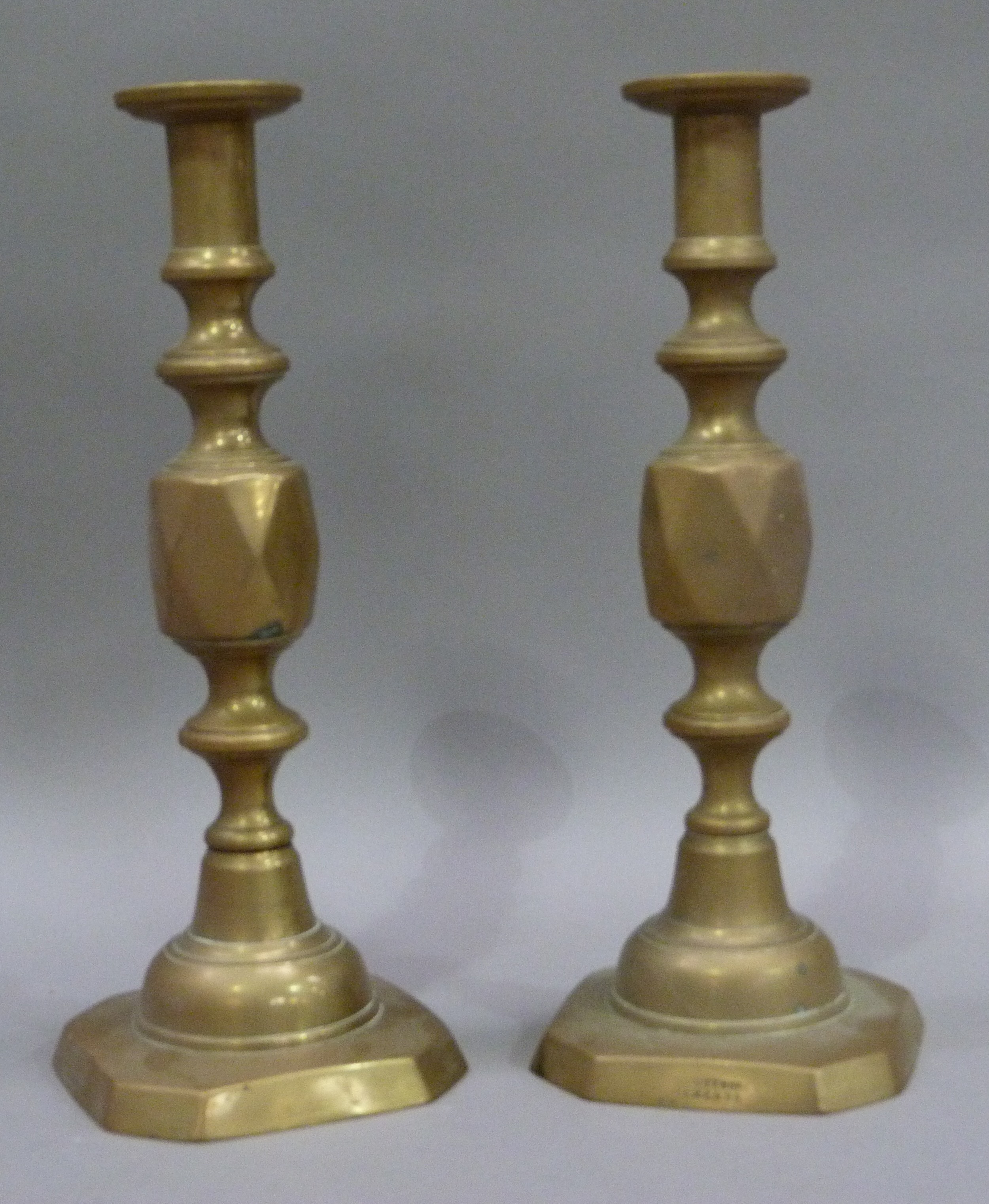 A pair of Victorian Queen of Diamonds brass table candlesticks, 29cm high