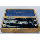 Stanley - a good Victorian oak cased set of drawing instruments in fitted blue velvet and silk lined