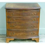 A reproduction mahogany bachelors chest in George style the butterfly veneered top within broad