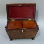 A post Regency figured mahogany sarcophagus shaped tea caddy, the hinged lid revealing two