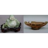 A carved jadeite buddha on hardwood base, 7cm high; together with a brown soapstone carving of a