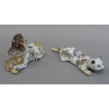 A 19th century Faience pottery model of a cat, its back with crowned shield, flowers and foliage,