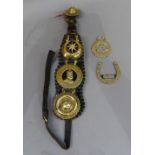 An Edwardian leather farthingale with brasses, one inscribed Edward VII God Save the King; two other