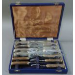 A set of James Dixon & Sons antler handled stainless steel steak knives and forks, cased