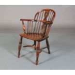 A 19TH CENTURY YEW WOOD LOW BACK WINDSOR ARMCHAIR having a pierced and rail back, turned uprights,