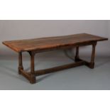 AN OAK REFECTORY TABLE, 19th century having a planked top with cleat ends, plain apron and on cannon