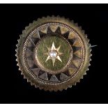A VICTORIAN PEARL SET SHIELD BROOCH in 15ct gold, star set to the raised centre with a 3mm half