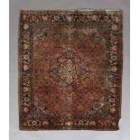 A CAUCASIAN RUG, the fox red field with dark blue lozenge medallion and spandrels, filled with