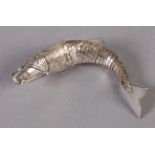 A SILVER ARTICULATED FISH PILL BOX with hinged head, engraved and having red enamel eyes, the