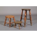 A 19TH CENTURY ELM STOOL, the chamfered rectangular top on three simple turned legs, 24cm diameter x