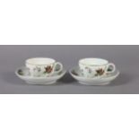 A PAIR OF RUSSIAN PORCELAIN CUPS AND SAUCERS each polychrome decorated with flowers and leafage, the