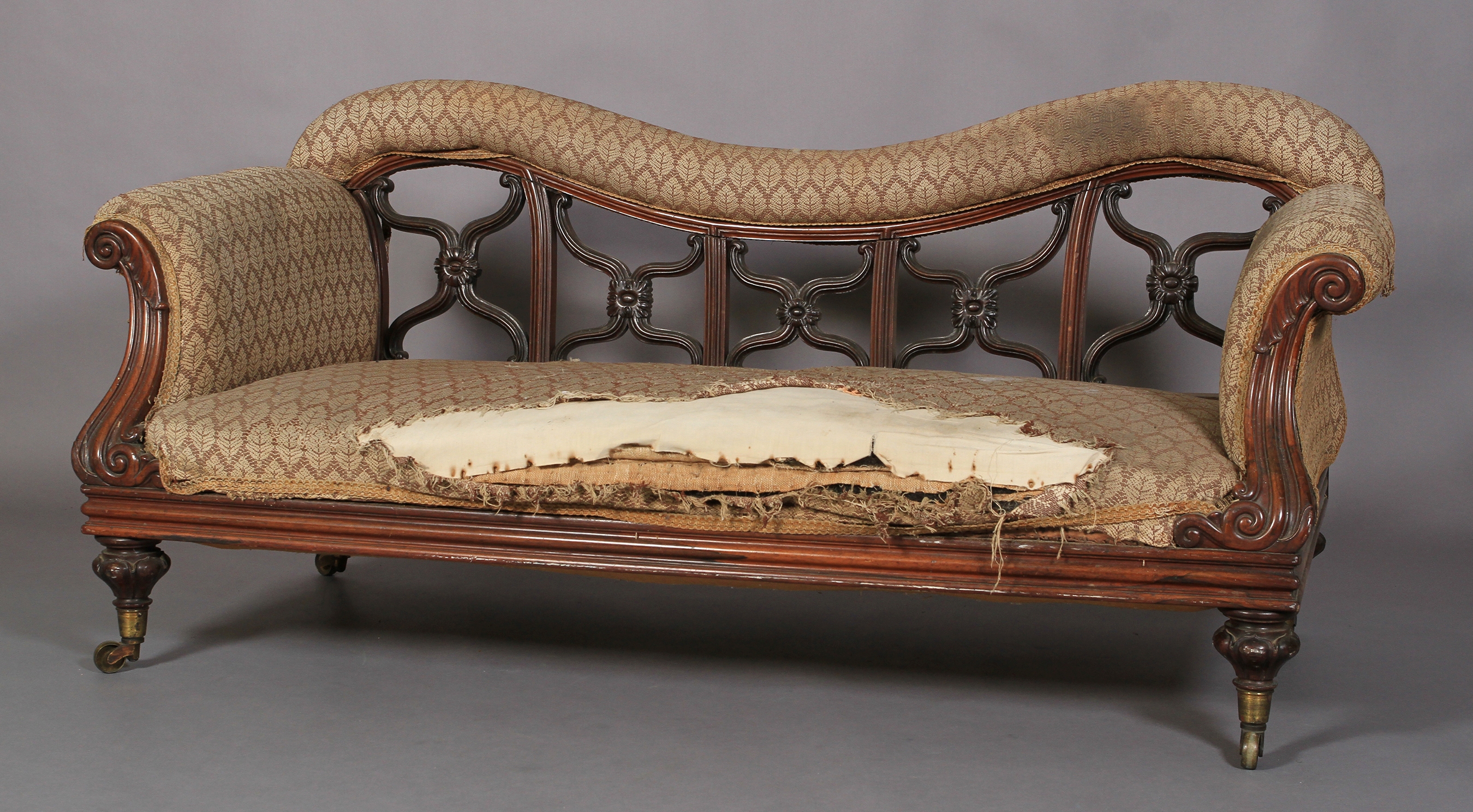 AN EARLY VICTORIAN ROSEWOOD SHOW FRAME SOFA, with upholstered top rail above moulded x-frame