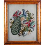 A VICTORIAN PLUSH WOOLWORK PICTURE with glass beadwork leaves of a peacock amidst flowers and
