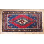 A FINE BIDJAR HAND MADE CARPET having a blue stepped medallion centred with a red on ivory stepped