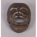 A JAPANESE CAST IRON MASK OF 'OKINA' FORM with detached chin, open slit eyes and triple wrinkled