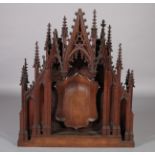 A VICTORIAN OAK 'GOTHIC' ALTAR PIECE of arched spire and flattened cluster column form, the centre