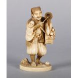 A LATE 19TH CENTURY JAPANESE IVORY OKIMONO OF A PEDLAR carrying a small chest, gourds and a noh mask