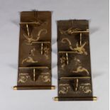 A PAIR OF JAPANESE GREEN LACQUER WALL SHELVES, each set with three folding brackets, decorated