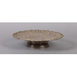 A GEORGE V SILVER TAZZA, circular, having a wide border pierced with fruiting vine and conforming