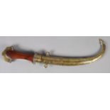 A MIDDLE EASTERN DAGGER (JAMBIYA) curved blade 21.5cm long, hardwood grip with chased white metal