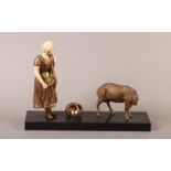 A CONTINENTAL GILT SPELTER FIGURE GROUP of a young girl with upturned basket and sheep beside, ivory