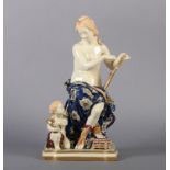 A WORCESTER FAIENCE POTTERY FIGURE of a lightly clad female artist, seated with a scroll framed