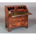 AN EARLY 18TH CENTURY FIGURED WALNUT CROSSBANDED AND BANDED BUREAU having a drop front, the interior