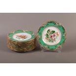 A SET OF TWELVE MID 19TH CENTURY ENGLISH CHINA DESSERT PLATES, each polychrome painted with a