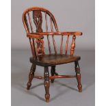 A CHILD'S EARLY 19TH CENTURY YEW WOOD WINDSOR ARMCHAIR having a pierced splat and rail back, elm
