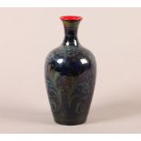 A BERNARD MOORE GLAZED STONEWARE VASE c.1905, ovoid with narrow neck, flambe painted with a formal