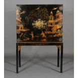 A CHINESE BLACK AND GILT LACQUERED CABINET ON STAND, 19th century, having two doors gilt with