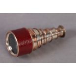 A SIX DRAWER SILVER PLATED ON COPPER MONOCULAR with red Morocco leather cased barrel, 9cm long