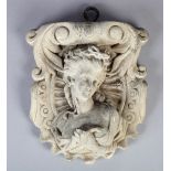A WHITE MARBLE CARTOUCHE SHAPED BRACKET carved with head and shoulder bust of a young woman with