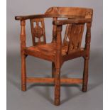 A THOMPSON OF KILBURN 'MOUSEMAN' ENGLISH OAK MONK'S CHAIR the top rail terminating with a face