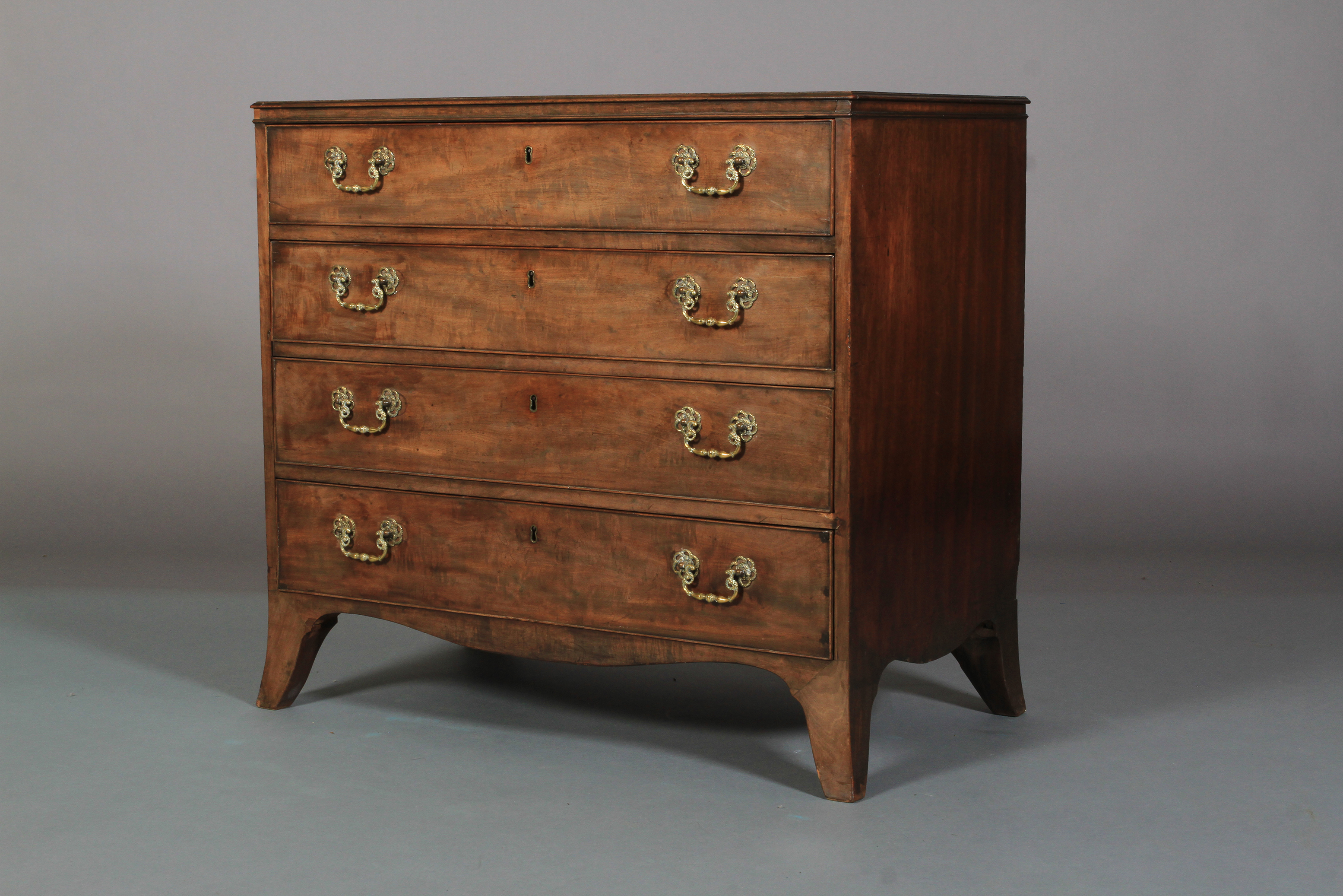 AN EARLY 19TH CENTURY MAHOGANY DRESSING CHEST of four drawers, fitted with a baise lined brushing