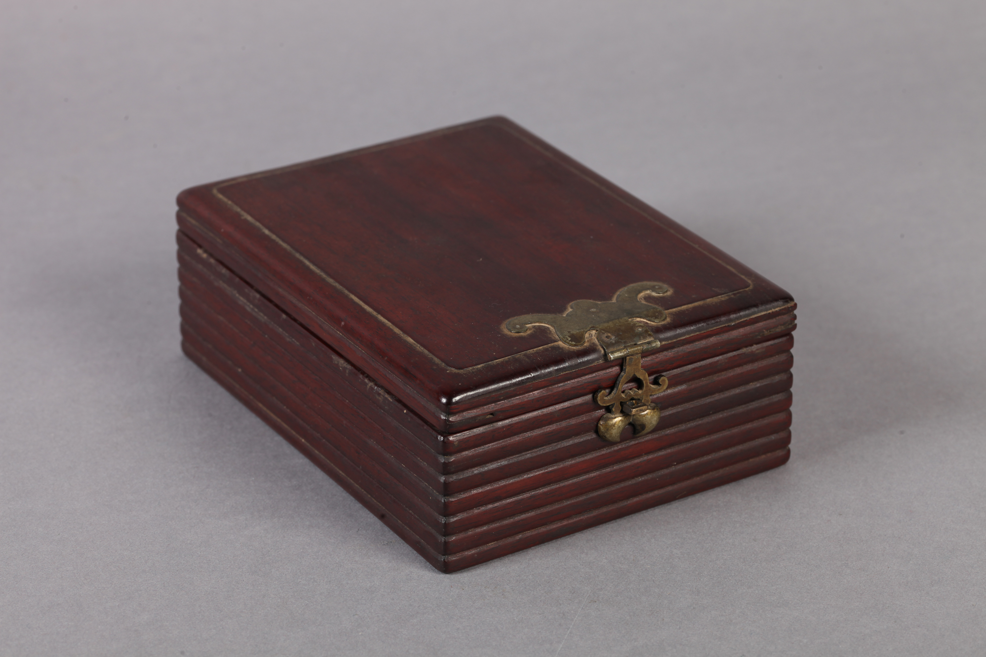 A CHINESE HARDWOOD DRESSING TABLE BOX of rectangular form, the hinged lid with ribbed edge, the body - Image 2 of 2