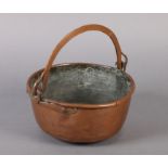 A 19TH CENTURY COPPER PAN of circular outline with swing handle 25.5cm over handles x 10.5cm high