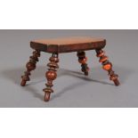 AN EARLY 19TH CENTURY YEW-WOOD FOOTSTOOL, the rectangular burr wood top with cut-away corners, on