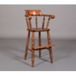 A CHILD'S 19TH CENTURY HIGH CHAIR in ash, beech and elm having a bow back with turned spindles, on