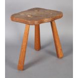 AN ALAN GRAINGER OF BRANDSBY 'ACORN MAN' ENGLISH OAK THREE LEGGED STOOL with free-form top and