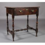 A 17TH CENTURY OAK SIDE TABLE the oversailing top above a single deep drawer, slender baluster
