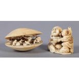 A LATE 19TH CENTURY JAPANESE NETSUKE of buddha and a young child, unsigned, 4cm high, together