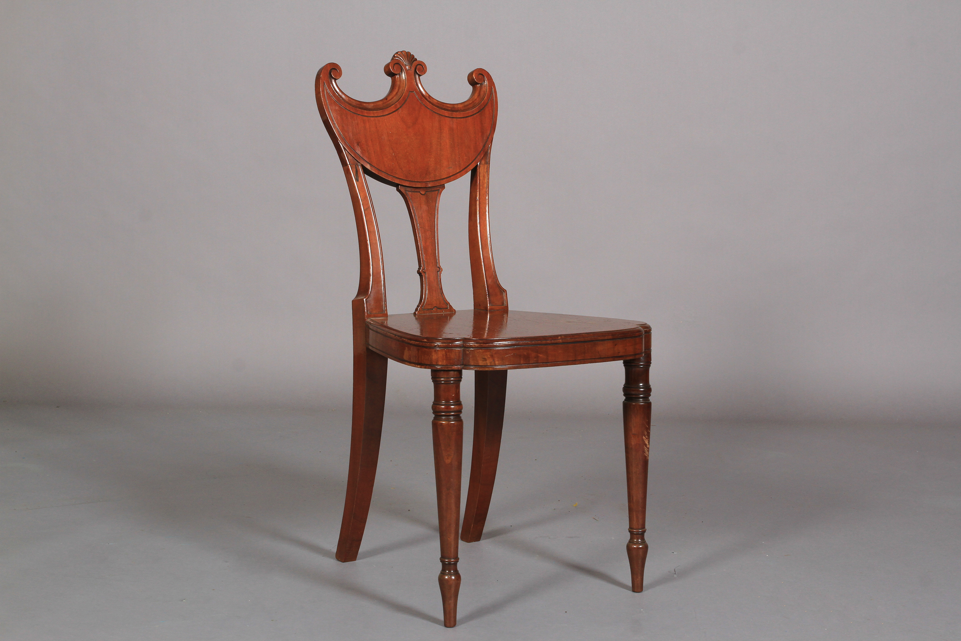 A GEORGE IV MAHOGANY HALL CHAIR with swag and splat back, on slender turned legs