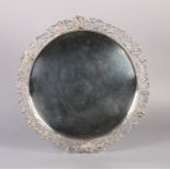 A GEORGE VI SILVER SHAPED CIRCULAR TRAY, the border cast and fret cut with vine leaves, grapes and
