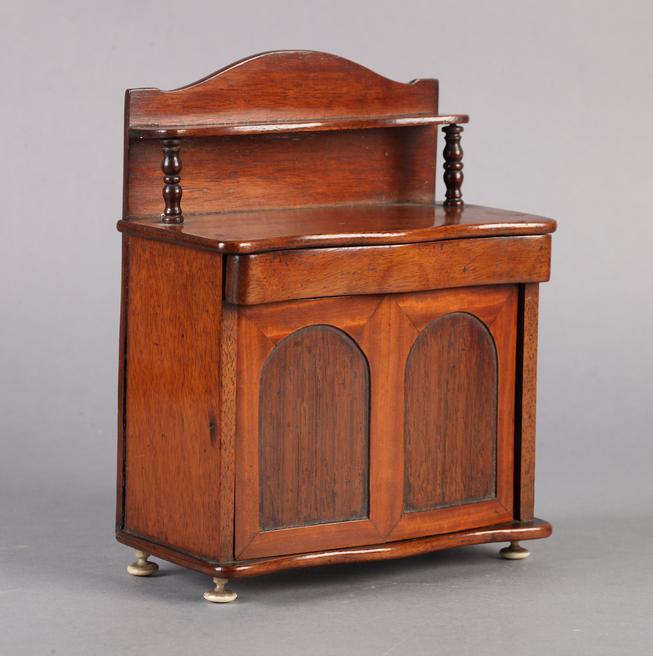A VICTORIAN MAHOGANY MINIATURE CHEFFONIER MONEY BOX, of typical design, serpentine fronted, the