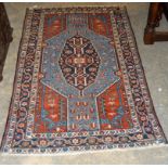 AN ANTIQUE PERSIAN HAND MADE AFSHAR RUG having an oval stepped medallion on a pale blue panel, on an