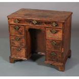 AN 18TH CENTURY WALNUT CROSSBANDED KNEEHOLE DESK, the top quarter veneered and inlaid with