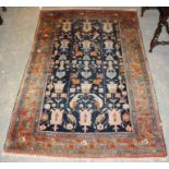 AN ANTIQUE PERSIAN HAND MADE ZANJIAN RUG, the blue field with all-over stylised plant forms in