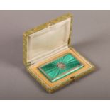 A CONTINENTAL SILVER AND BRIGHT GREEN ENAMEL BOX, the hinged lid centred on a cut oval of love