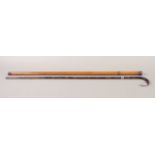 A 19TH CENTURY MALACCA WALKING CANE, in two screw off sections containing a small drinking glass and